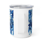 A white insulated tumbler with a clear lid and a vertical blue abstract floral pattern wrapping around the sides, shown on a clean white background.