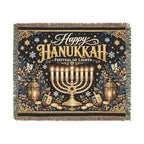 A square woven tapestry throw blanket with fringe on all sides, featuring a Hanukkah design with a golden menorah, stars, lanterns, coins, and the text 'Happy Hanukkah Festival of Lights' on a dark navy background.
