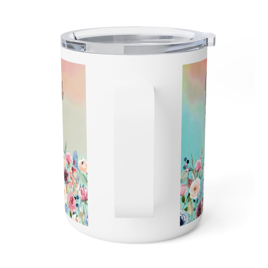 A white insulated travel mug with a clear lid and handle, featuring pastel watercolor floral panels on the sides.