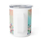 A white insulated travel mug with a clear lid and handle, featuring pastel watercolor floral panels on the sides.