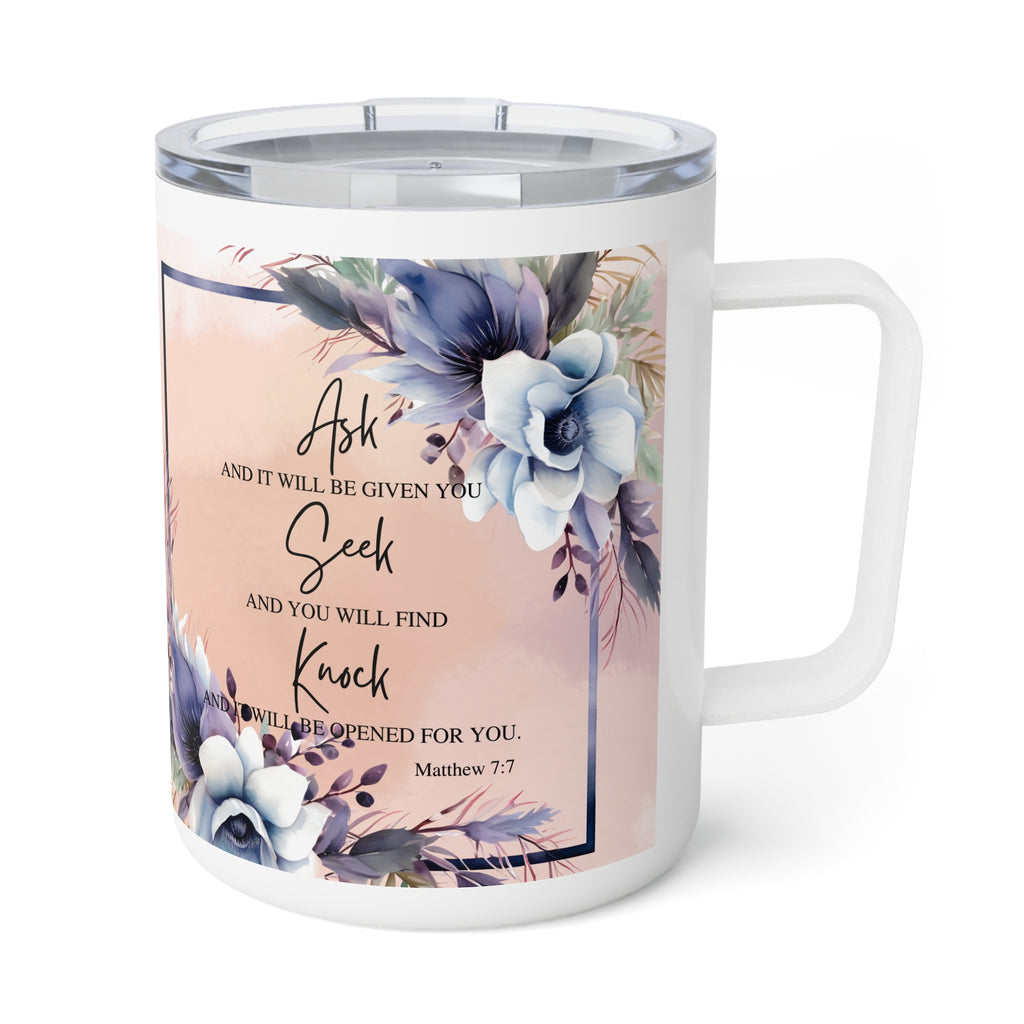 A white insulated travel mug with a clear lid and a printed floral design featuring blue and purple flowers on a soft peach background, with the text 'Ask and it will be given you, Seek and you will find you, Knock and it will be opened for you. Matthew 7:7'.