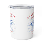A white insulated tumbler with a clear lid, featuring a blue and red tropical beach graphic and partial text reading 'STAY S.