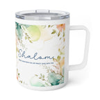 A white insulated travel mug with a clear lid and handle, decorated with a watercolor floral design in soft green, peach, and blue tones, featuring the word 'Shalom' and a small quote on a white background.