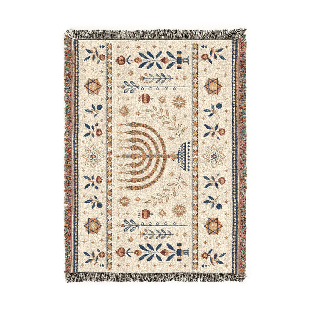 A rectangular woven rug with a cream background and multicolor traditional patterns, featuring a central menorah motif and fringed edges, shown flat against a white background.
