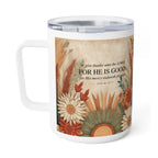 A white stainless steel  travel mug with a clear lid, featuring a printed autumn floral design and a Bible verse from Psalm 107:1 on the front.