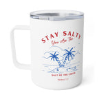 A white insulated travel mug with a clear lid, featuring a blue and red graphic of palm trees on a beach with the text 'STAY SALTY You Are The' and 'SALT OF THE EARTH' plus 'Matthew 5:13'.