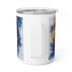 A white insulated travel mug with a clear lid and a vertical handle, featuring abstract blue and gold watercolor-style printed panels on the sides, shown on a white background.