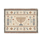 A rectangular woven tapestry rug with a central menorah motif and decorative floral and geometric borders, shown flat against a plain white background.