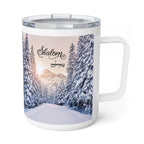 A white stainless steel  travel mug with a clear plastic lid, featuring a printed winter landscape design of a snow-covered forest and mountains with the word 'Shalom' in black script.