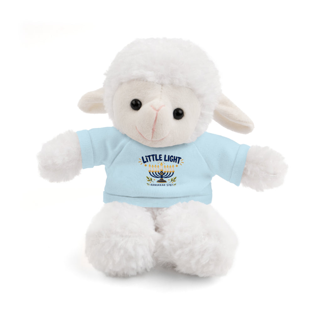 A white plush lamb toy wearing a light blue t-shirt with a 'Little Light Shined Before' menorah graphic, set against a plain white background.