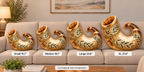 Four decorative horn-shaped shofar decorative pillows displayed on a beige sofa in a living room setting, labeled Small 15.7", Medium 19.