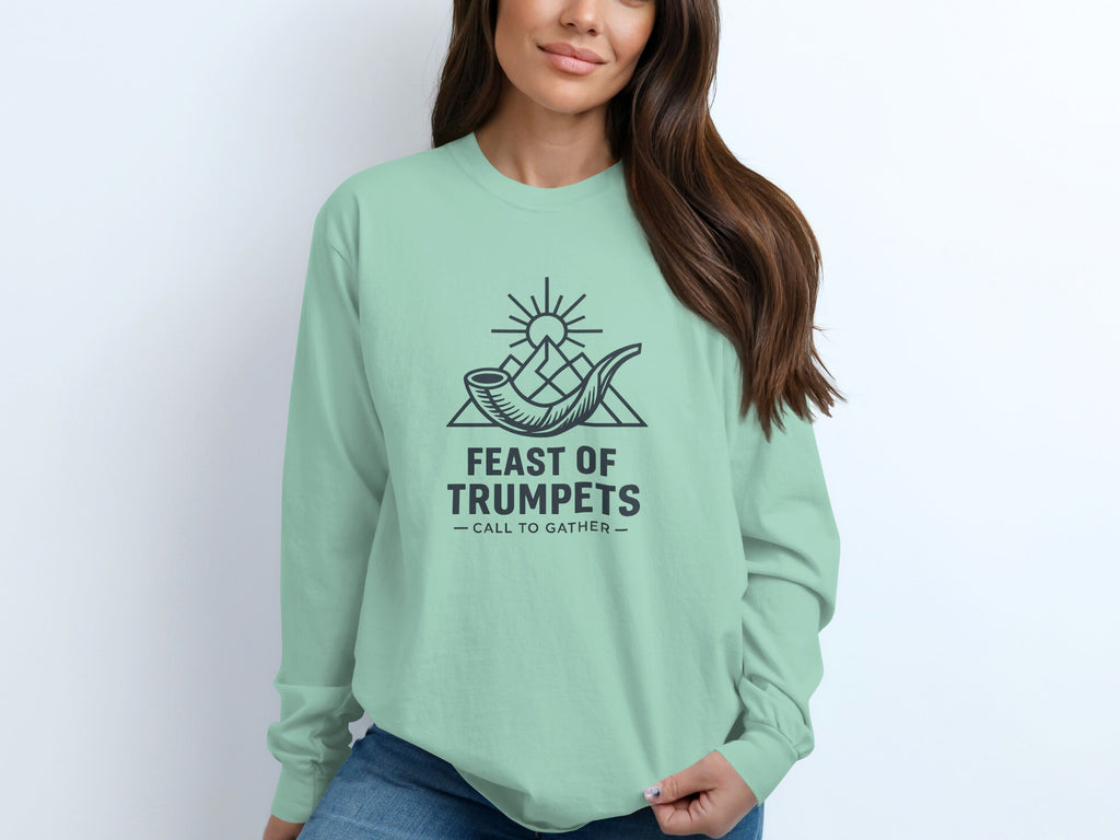Mint green long-sleeve shirt with "Feast of Trumpets" graphic.