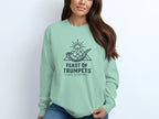 Mint green long-sleeve shirt with "Feast of Trumpets" graphic.