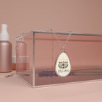 Teardrop-shaped pendant with 'I ❤️ MAGA TEARS' text on a pink background