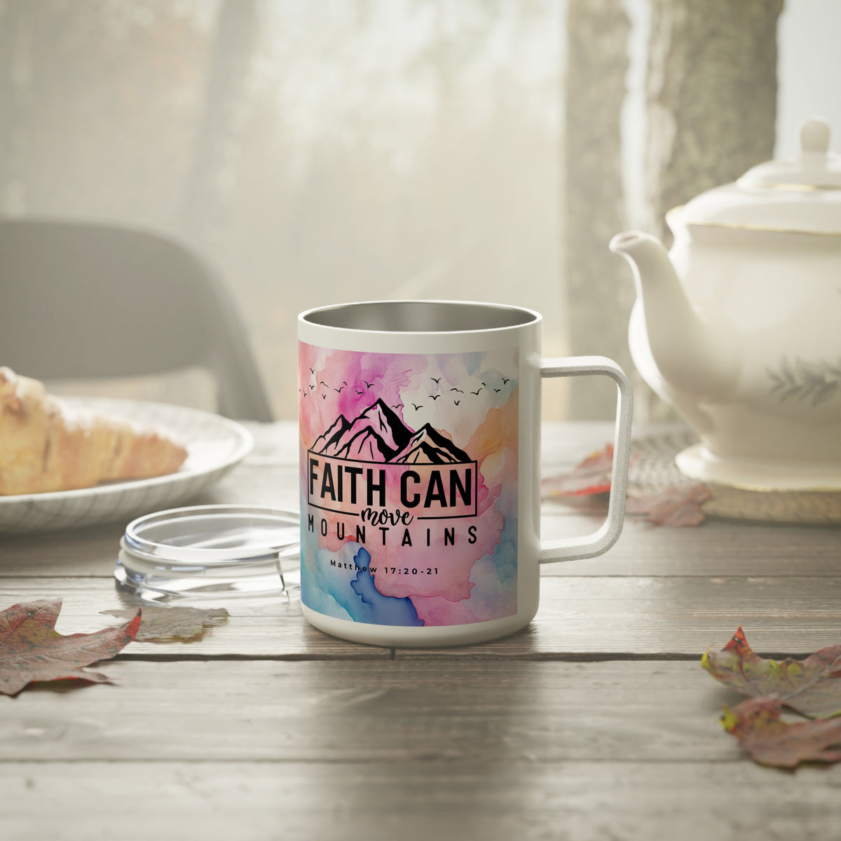 A white stainless steel coffee mug with a colorful watercolor design featuring pink, blue, and purple hues, along with a black mountain graphic and the text 'FAITH CAN move MOUNTAINS' and 'MADE IN TX / 11.20.