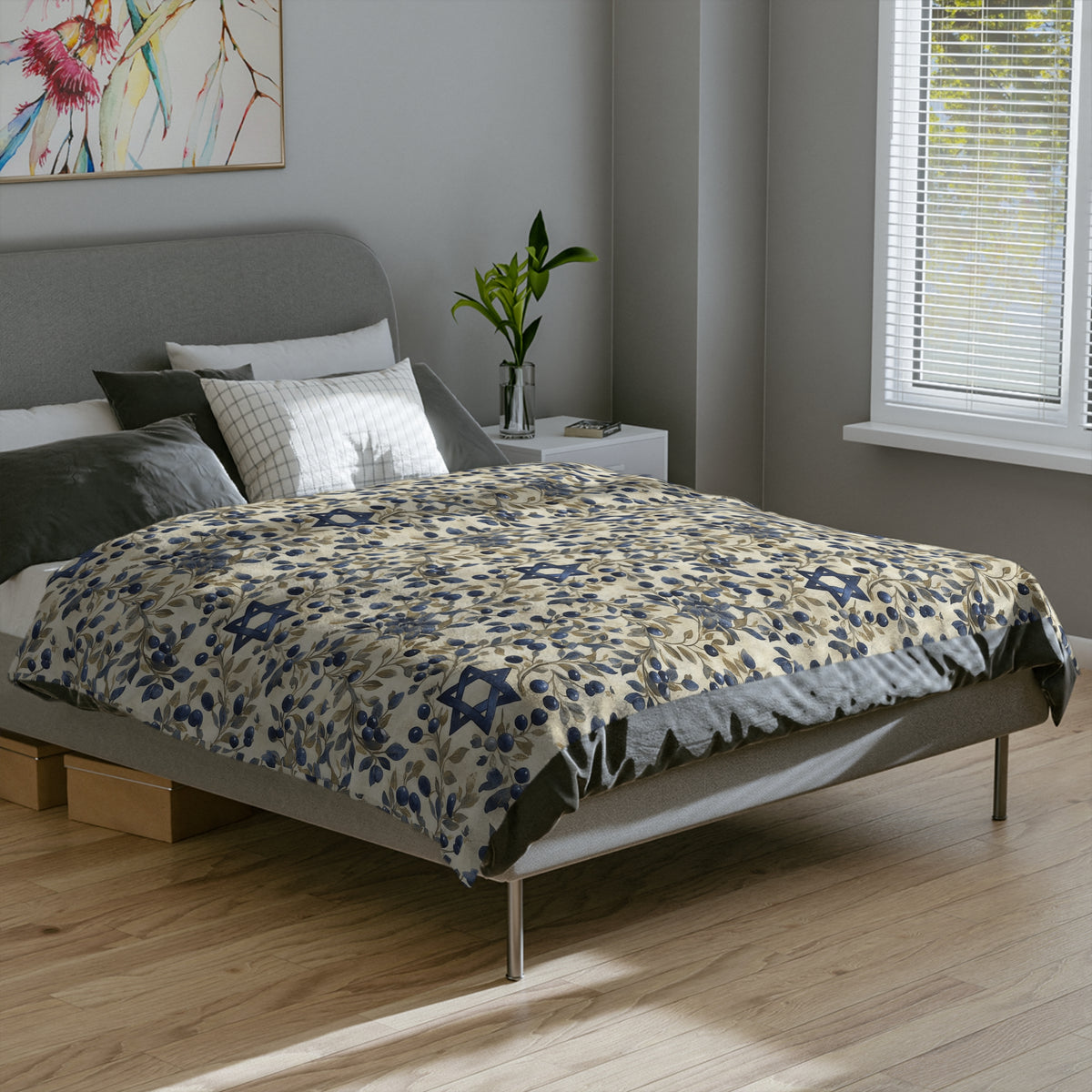 Blue Star of David botanical blanket covering the top of a gray bed