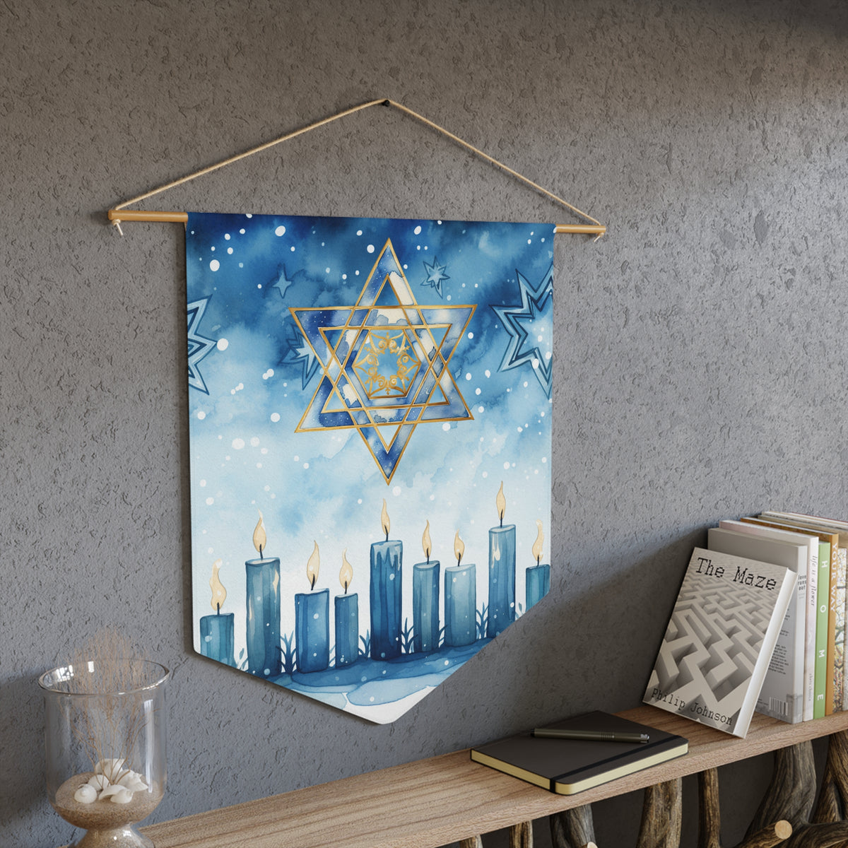 Festival of Lights wall pennant with a gold Star of David over a row of blue Hanukkah candles, above a bookshelf