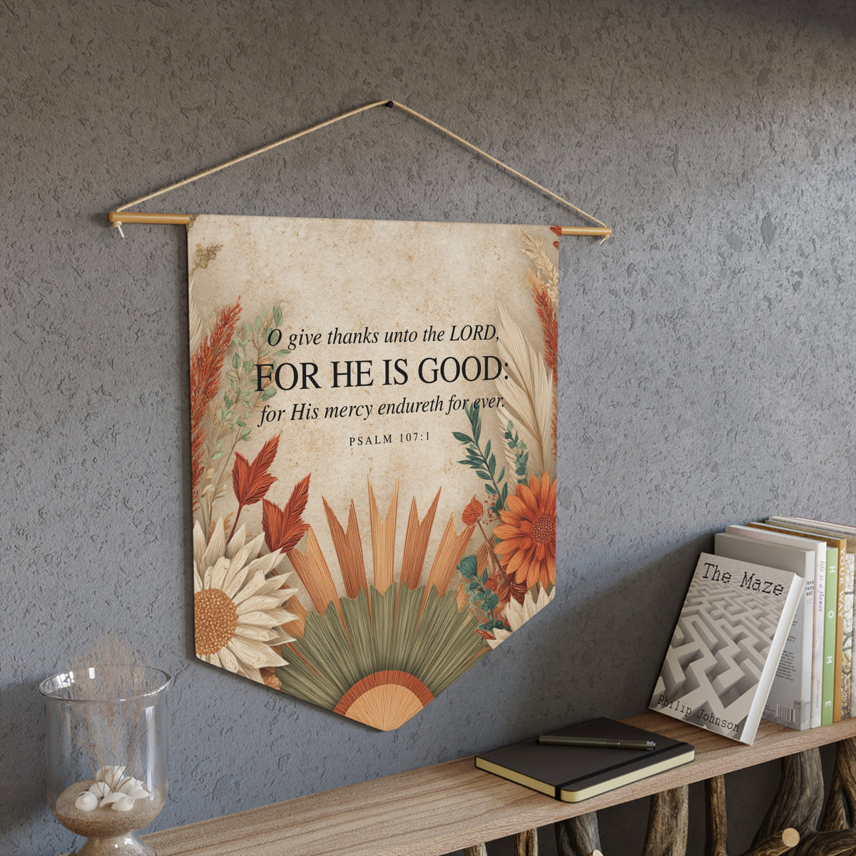 O give thanks unto the LORD, for He is good wall pennant with autumn flowers, Psalm 107:1, hanging on a gray wall above a bookshelf