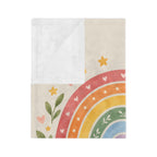Corner of the God's Promise rainbow blanket folded back to show the white reverse side