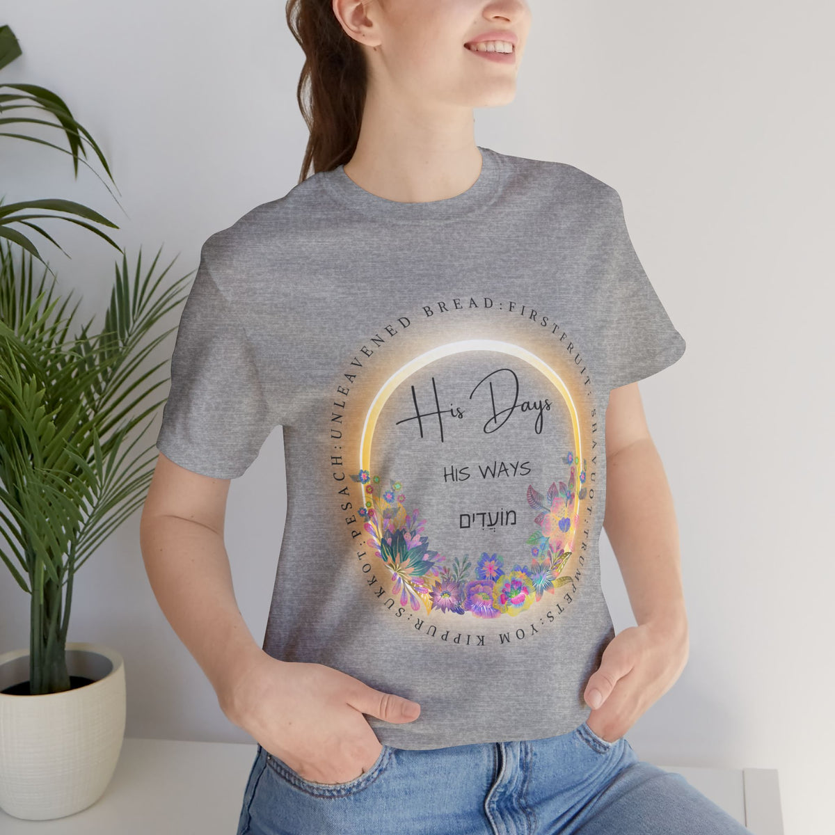 Athletic heather His Days His Ways tee with a floral ring of feast names and Hebrew lettering, worn by a woman