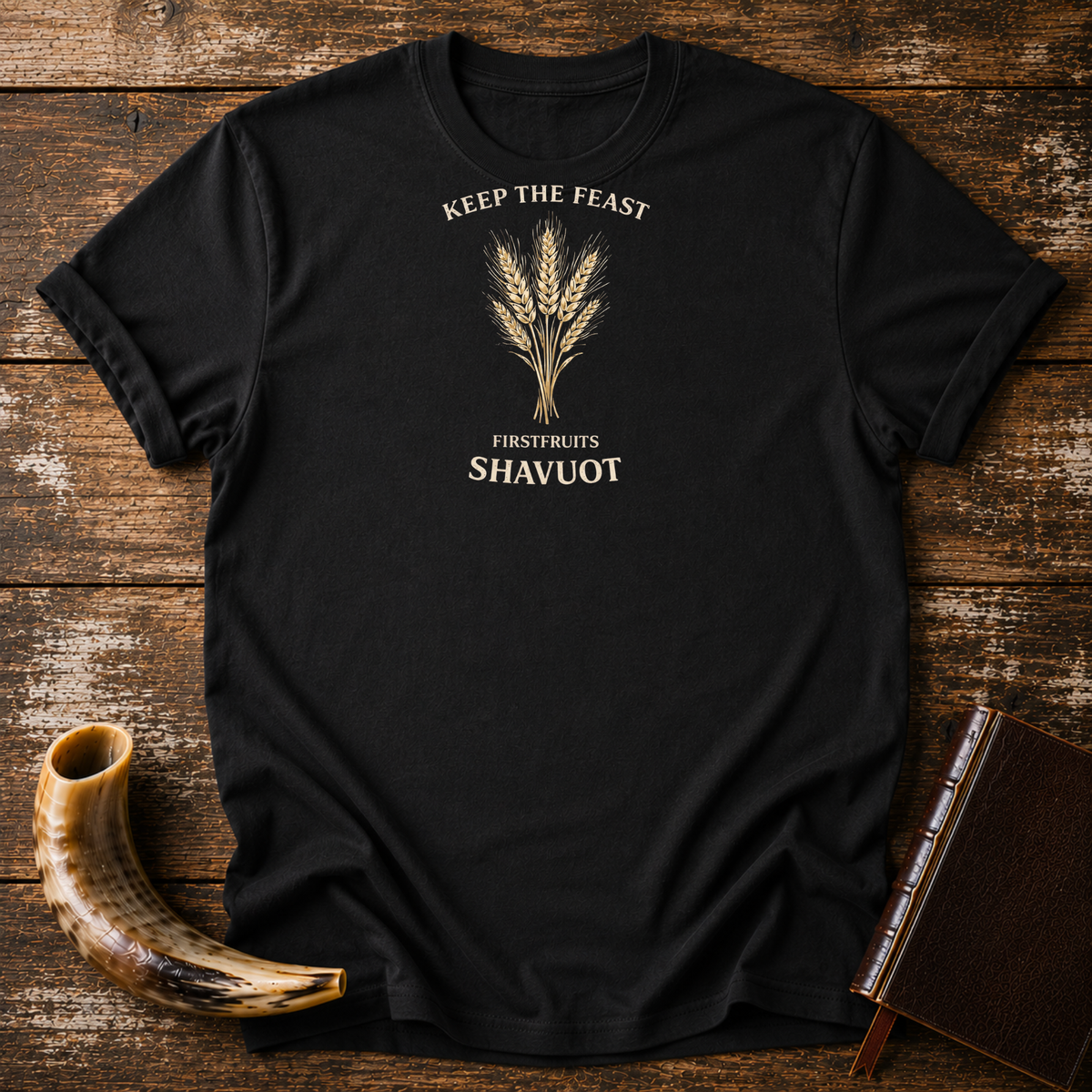 Black Keep the Feast Firstfruits Shavuot tee with a cream wheat sheaf, laid flat with a shofar and a leather-bound book