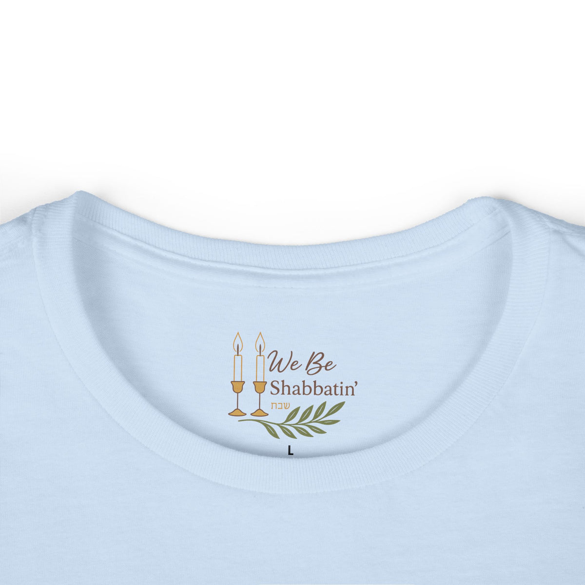 Close-up of the We Be Shabbatin' neck label inside a light blue t-shirt