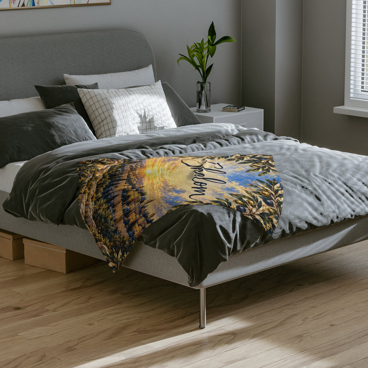 Shalom Jerusalem olive branch blanket laid across the foot of a gray bed