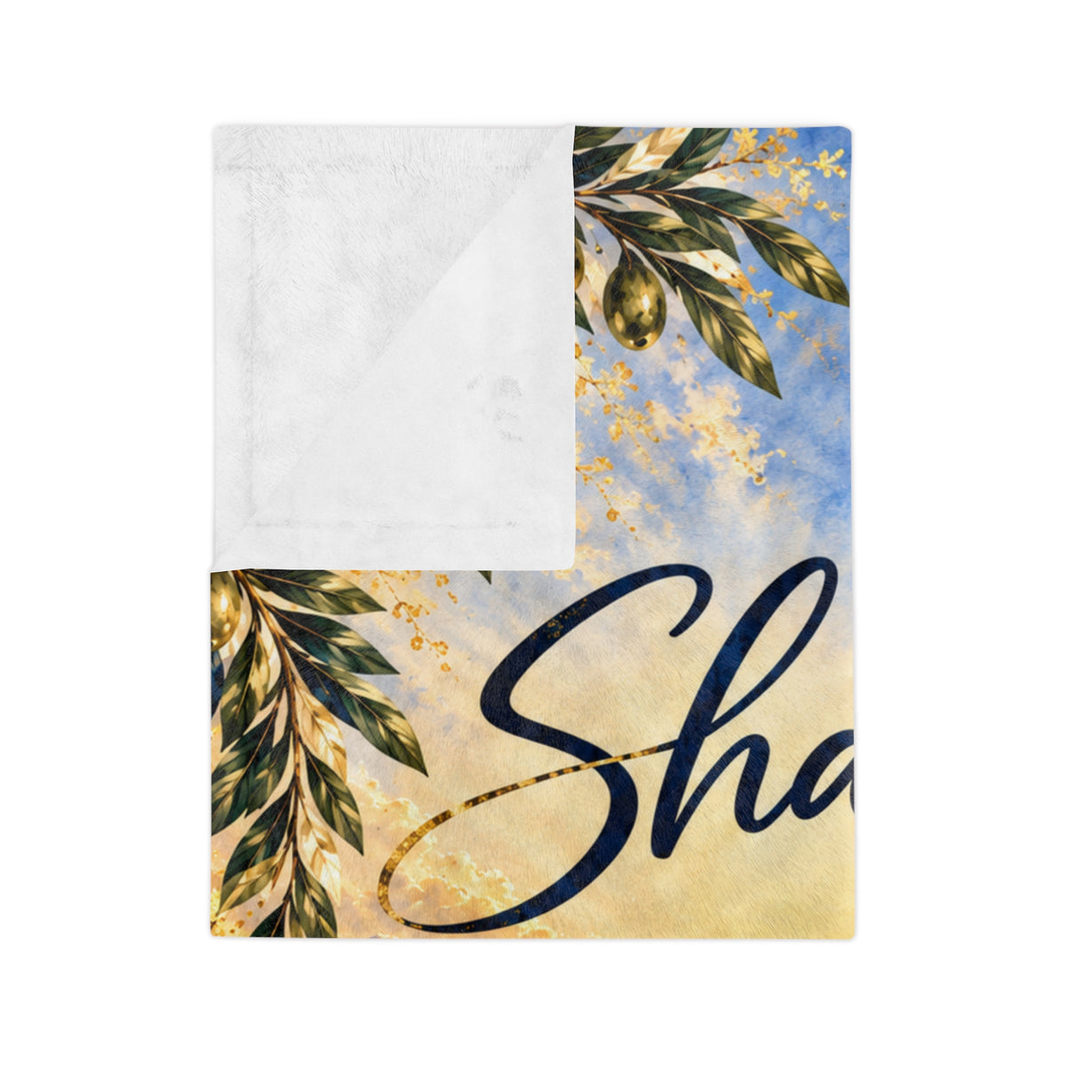 Folded corner of the Shalom Jerusalem blanket showing olive branches, script and white fleece back