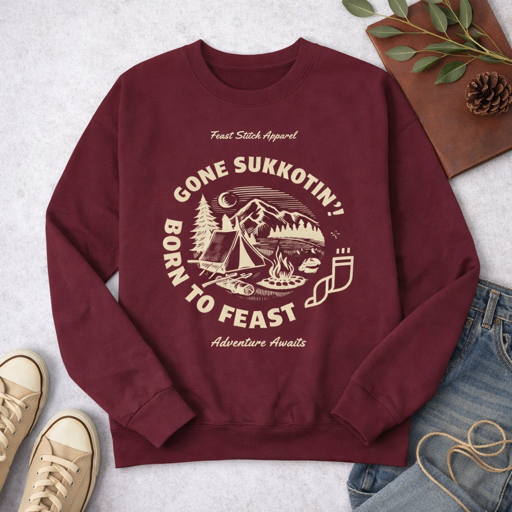 Maroon Gone Sukkotin' Born to Feast youth sweatshirt laid flat with jeans, sneakers, pinecone and leaves