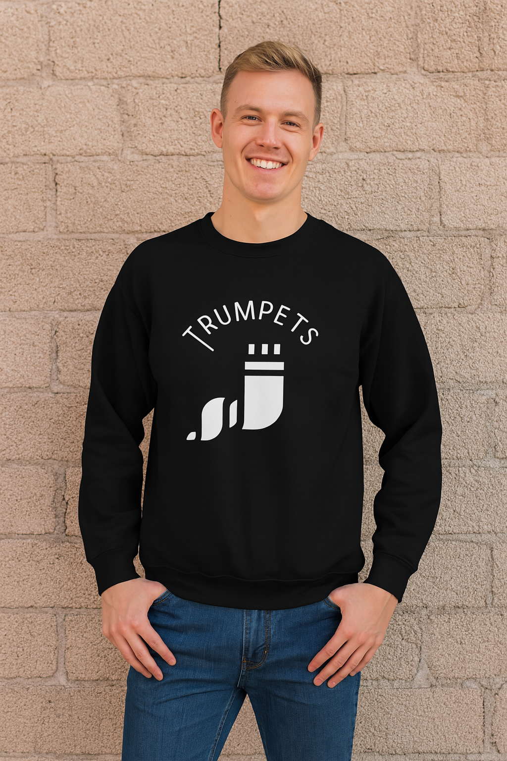 Black Trumpets long sleeve shirt with a white shofar graphic, worn by a smiling man against a brick wall