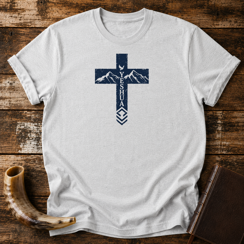 Sport grey Yeshua cross t-shirt with mountains and a dove in the cross, laid flat with a shofar and Bible